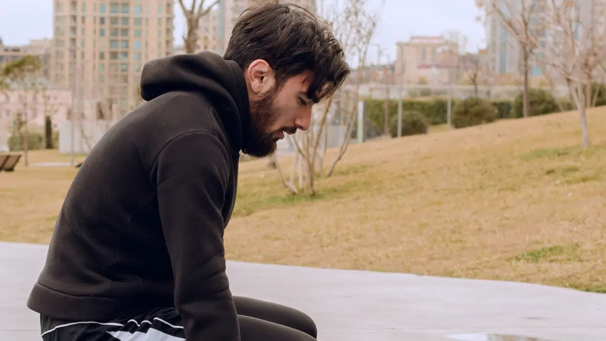 Man comforting another man. Rising concern over climate change is fueling a surge in mental health issues, including addiction.