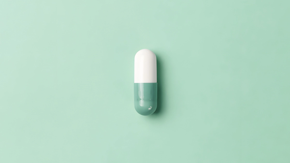 Mint green background with a white and mint green pill.