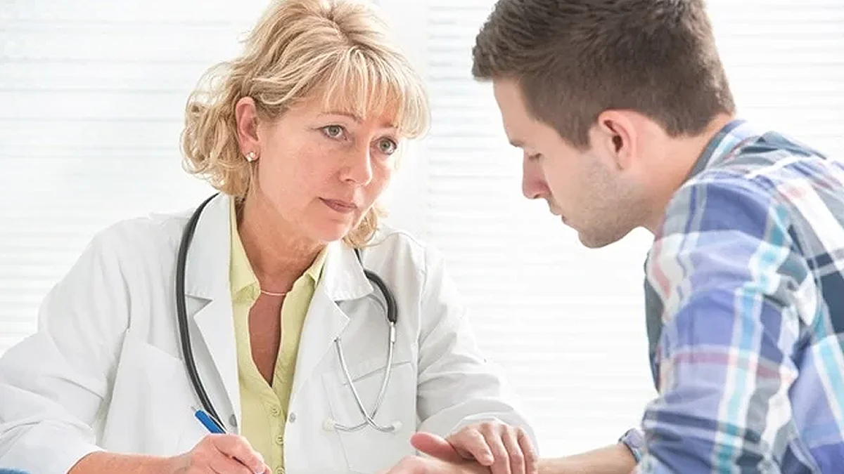 Female doctor speaking with male patient.