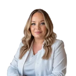 A headshot of a smiling woman with brown hair wearing a white jacket.
